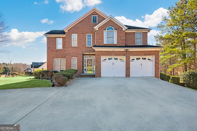 view of front of house featuring a front yard and a garage