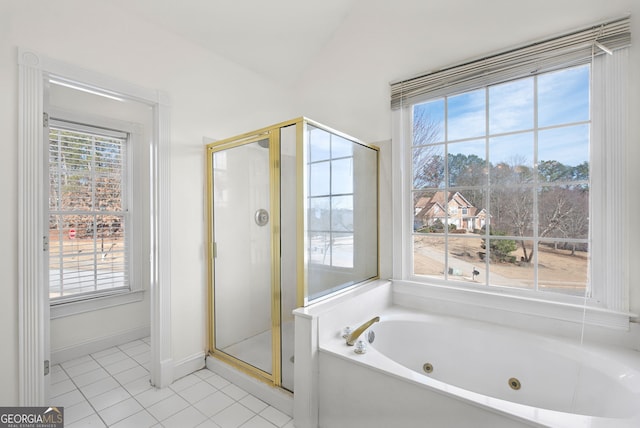 bathroom with vaulted ceiling, tile patterned floors, and shower with separate bathtub