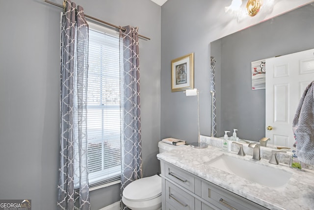 bathroom featuring toilet and vanity