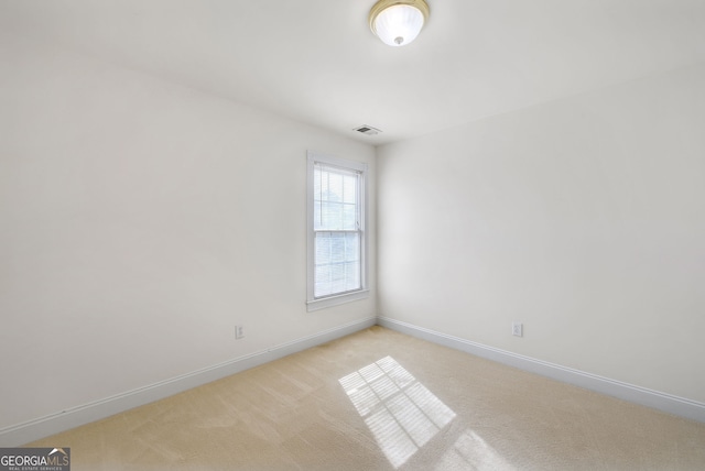 empty room featuring light carpet