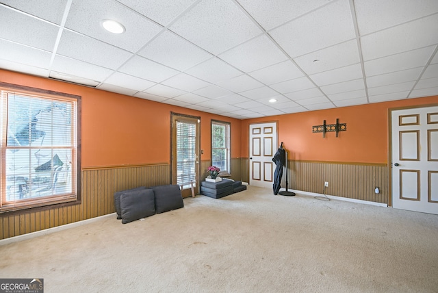 unfurnished room featuring carpet floors and a drop ceiling