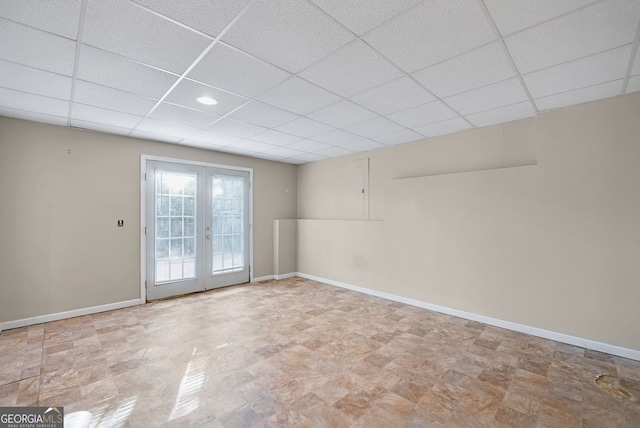 unfurnished room with a paneled ceiling and french doors