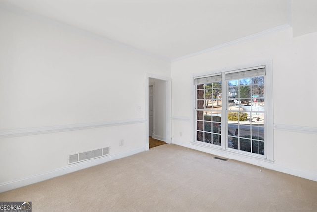 empty room with light colored carpet and ornamental molding