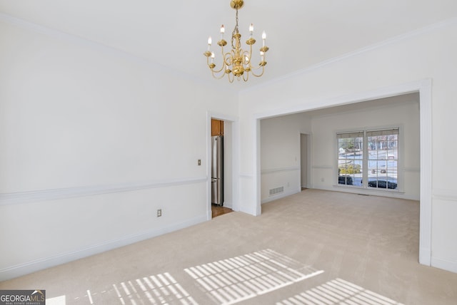 spare room with ornamental molding, light colored carpet, and a chandelier