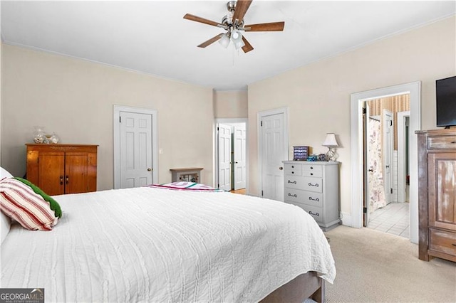 bedroom featuring connected bathroom, ceiling fan, and light carpet