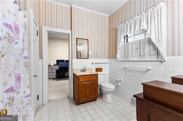 bathroom featuring tile patterned floors, vanity, tile walls, and toilet