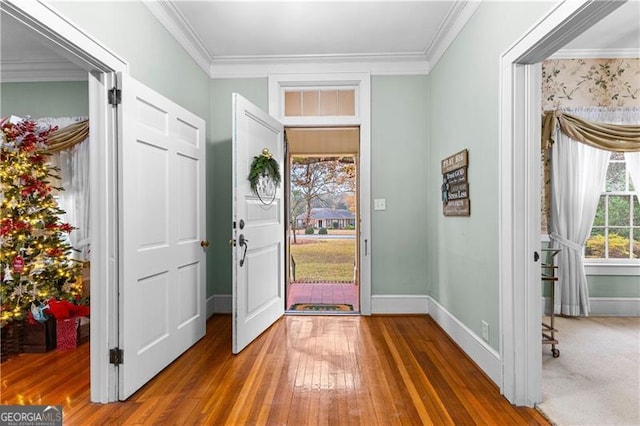 foyer entrance featuring hardwood / wood-style flooring and crown molding