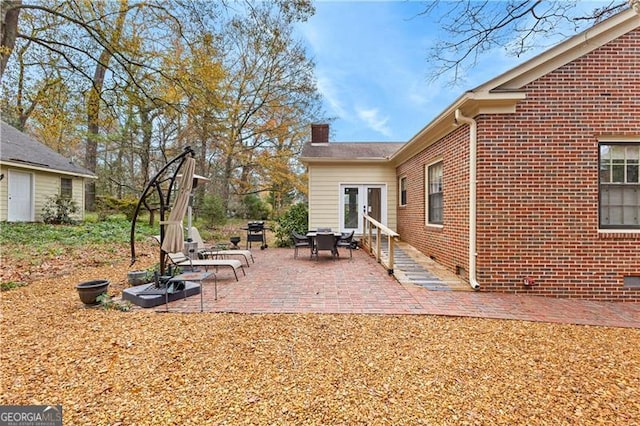 view of yard featuring a patio and french doors