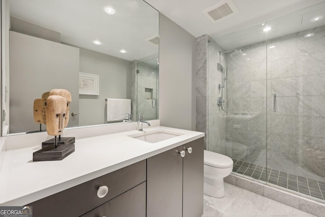 bathroom with vanity, an enclosed shower, and toilet