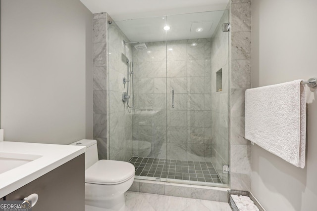 bathroom featuring vanity, toilet, and an enclosed shower