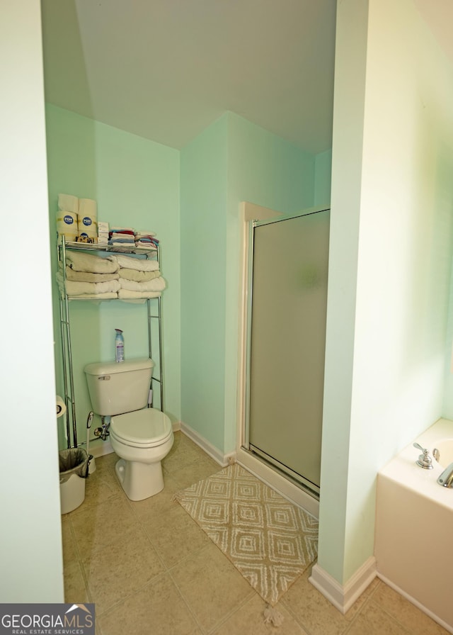 bathroom featuring separate shower and tub and toilet