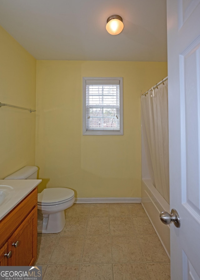 full bathroom featuring vanity, shower / bath combination with curtain, and toilet