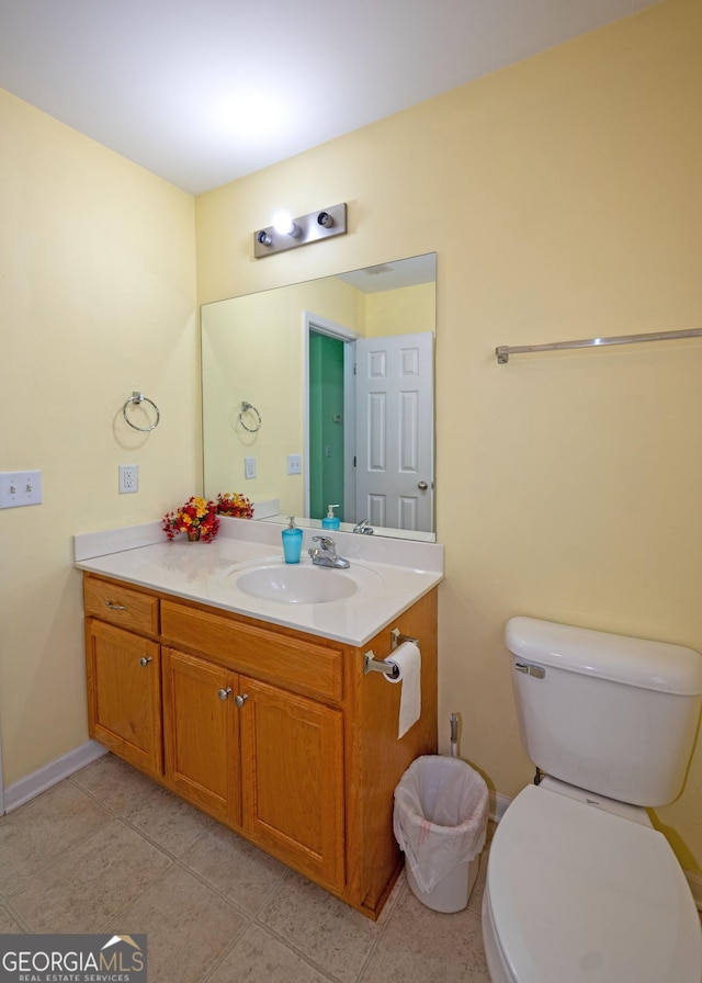 bathroom featuring tile patterned flooring, vanity, and toilet