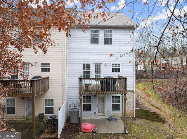 rear view of house featuring a patio area, a balcony, and central AC unit