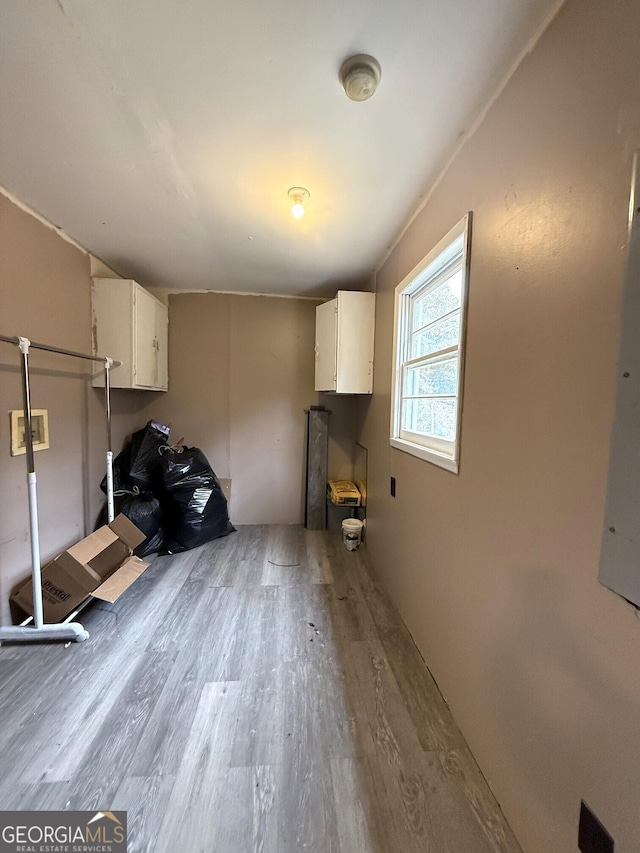 clothes washing area with light hardwood / wood-style flooring