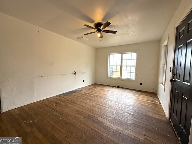 spare room with ceiling fan and dark hardwood / wood-style flooring