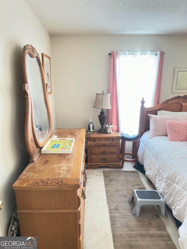 carpeted bedroom with a textured ceiling