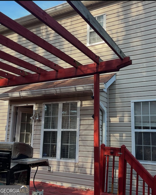 view of property exterior with a pergola