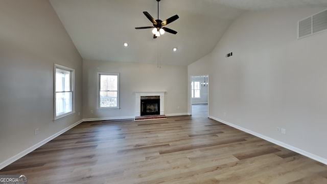 unfurnished living room featuring light wood-type flooring, high vaulted ceiling, and ceiling fan