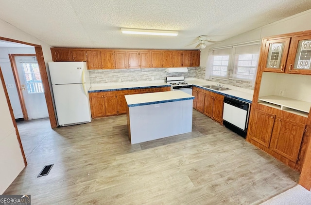 kitchen featuring white appliances, visible vents, decorative backsplash, and light wood-style floors