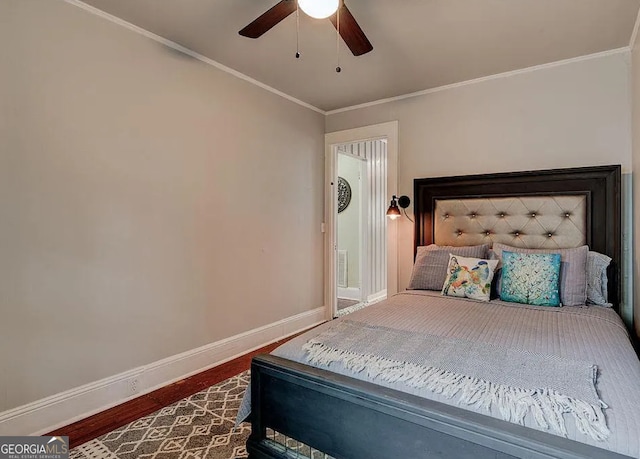 bedroom featuring wood-type flooring, ceiling fan, and crown molding