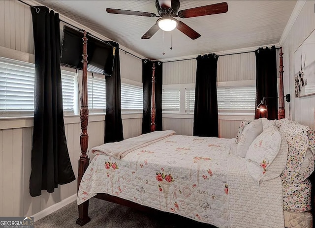 carpeted bedroom with multiple windows, ceiling fan, and ornamental molding