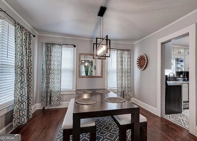 dining space with dark hardwood / wood-style floors, plenty of natural light, and crown molding