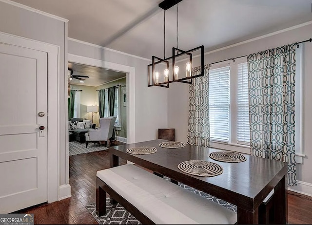 dining area with ceiling fan with notable chandelier, dark hardwood / wood-style flooring, and ornamental molding