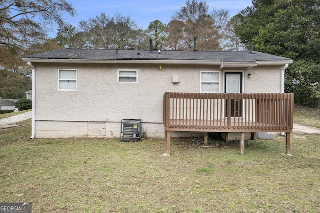 back of property featuring a yard and a wooden deck