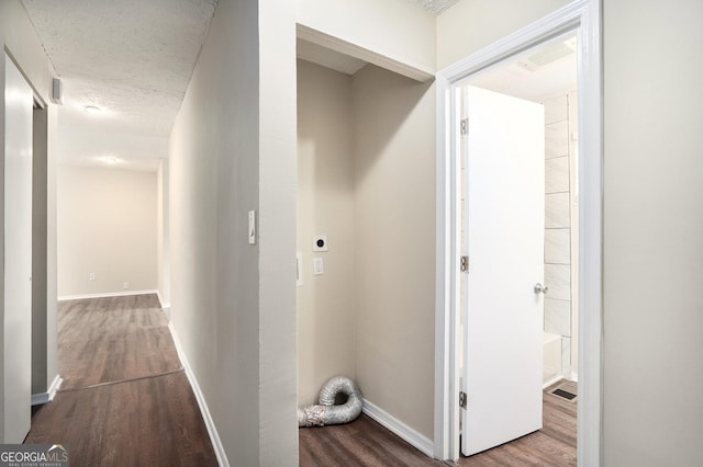 hall featuring hardwood / wood-style flooring and a textured ceiling