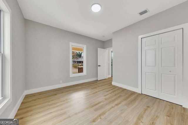 unfurnished bedroom featuring a closet and light hardwood / wood-style flooring