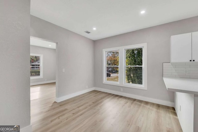 unfurnished dining area featuring light hardwood / wood-style flooring