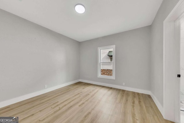 spare room with light hardwood / wood-style flooring