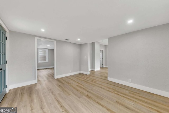 spare room with light hardwood / wood-style flooring