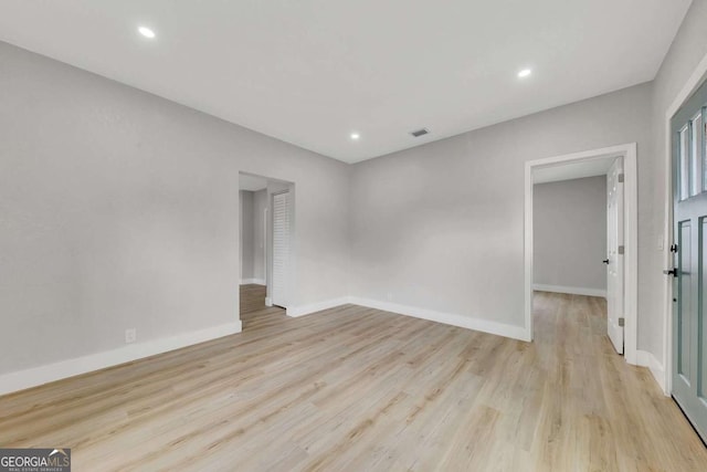 spare room featuring light wood-type flooring