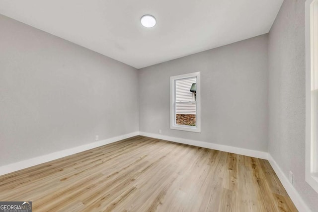 empty room with light hardwood / wood-style flooring