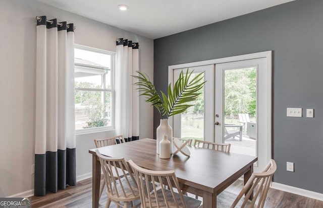 dining area featuring french doors, plenty of natural light, and wood-type flooring