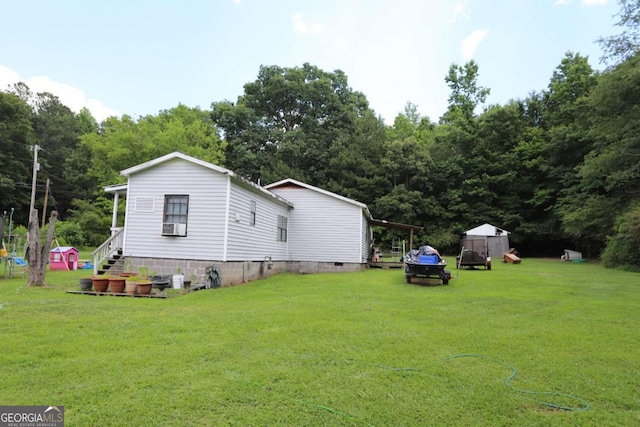 exterior space featuring a storage unit and a lawn