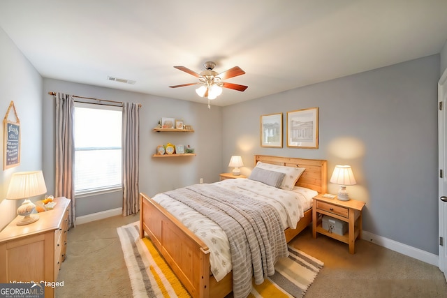 bedroom featuring visible vents, ceiling fan, light carpet, and baseboards