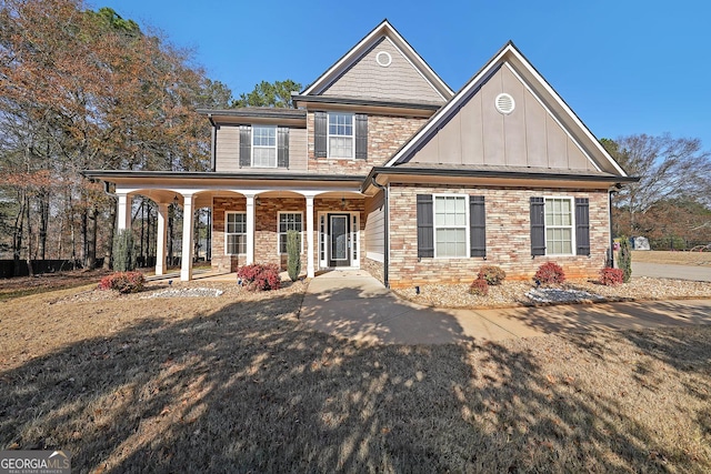 craftsman inspired home featuring covered porch, stone siding, and board and batten siding