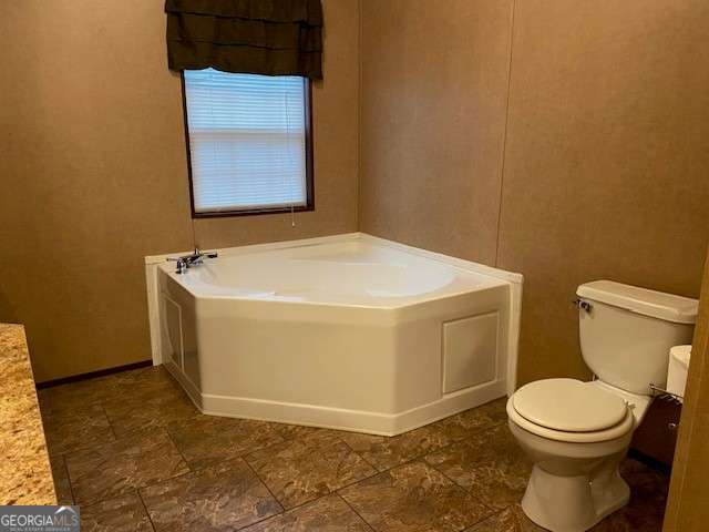 bathroom featuring toilet and a tub