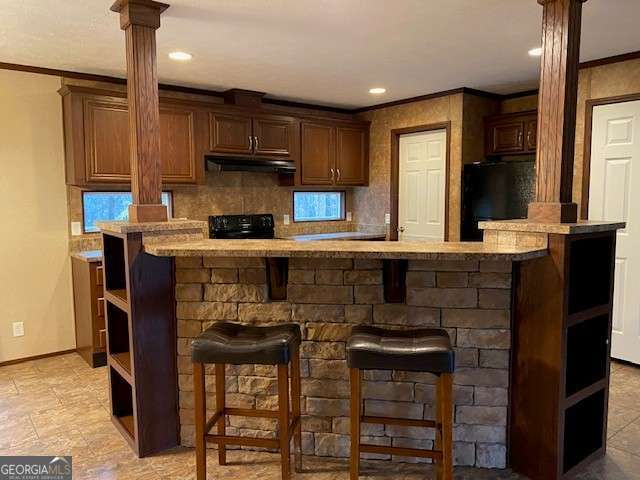 bar featuring tasteful backsplash, crown molding, decorative columns, and black appliances