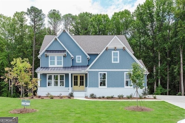 view of front facade with french doors and a front lawn