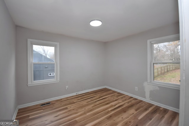 empty room with wood-type flooring