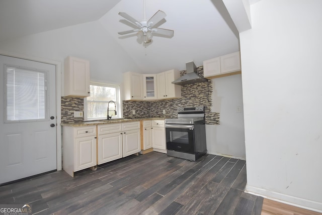 kitchen with wall chimney exhaust hood, stainless steel electric stove, dark wood-type flooring, sink, and high vaulted ceiling