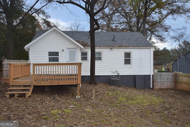 back of house with a deck