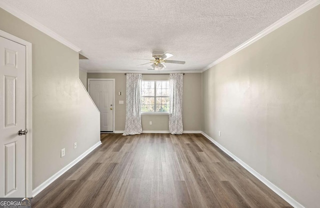 unfurnished room with wood-type flooring, a textured ceiling, ceiling fan, and ornamental molding