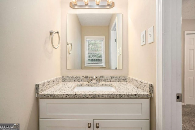 bathroom with vanity and a textured ceiling