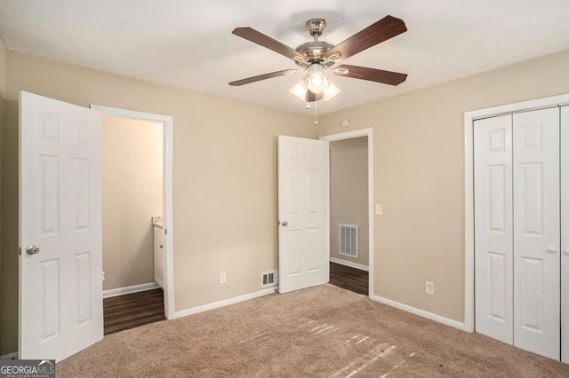 unfurnished bedroom with carpet, a closet, and ceiling fan