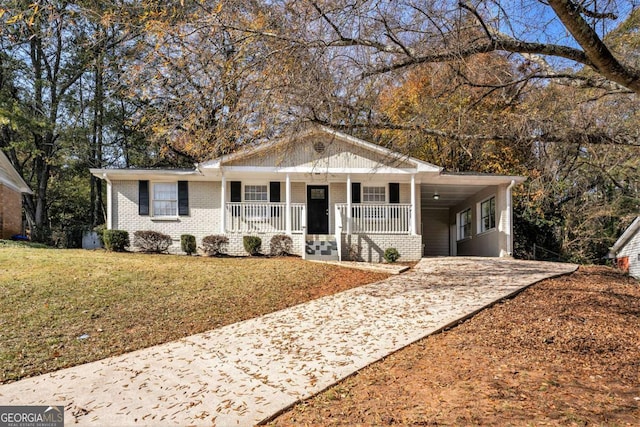 ranch-style home featuring a carport, a porch, and a front yard